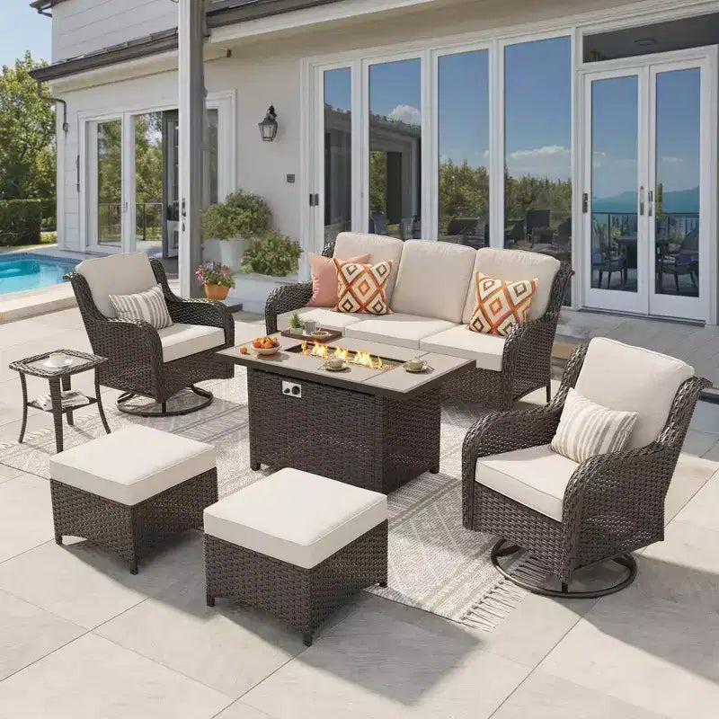 Ensemble de conversation de 7 meubles de patio Ovios Orlando en osier marron avec foyer rectangulaire, fauteuils pivotants et coussins