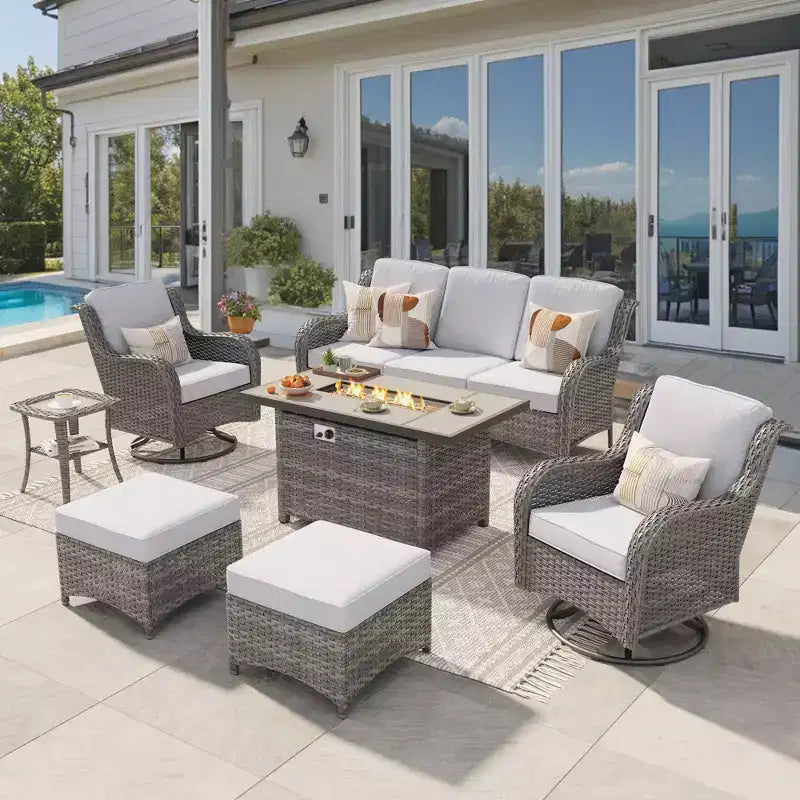 Ensemble de conversation de 7 meubles de patio Ovios Orlando en osier marron avec foyer rectangulaire, fauteuils pivotants et coussins